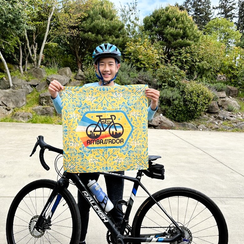 Tai holds up his Ambassador banner